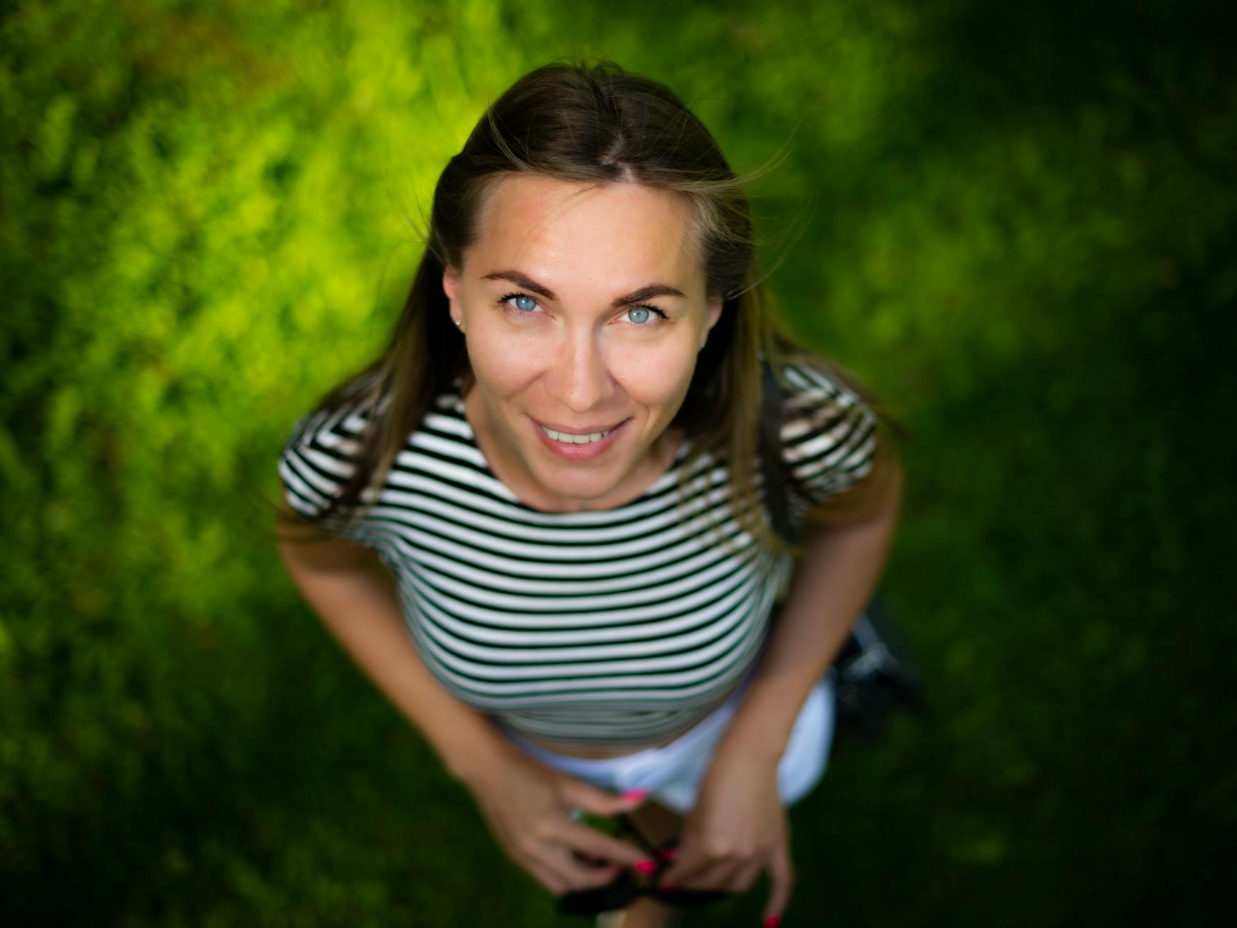 Uśmiechnięta młoda kobieta w parku w Wilnie w słoneczny dzień